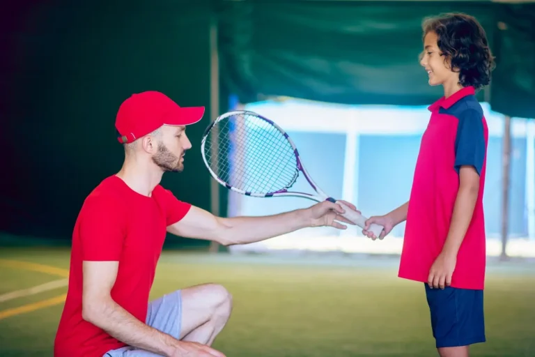 convertio.in_tennis-lesson-male-tennis-coach-red-clothes-teacjing-boy-hold-racket (1) (1) (1) (1)